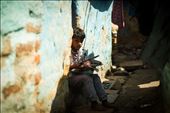 A boy does his school homework outside his house in a slum: by hashimhakeem, Views[240]