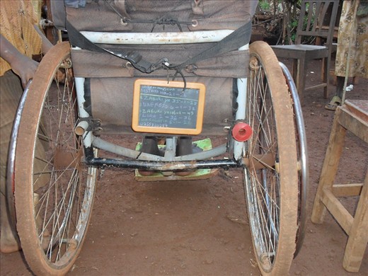 A Kiswahili-version bible verses reminder board attached at the back of the wheelchair. It makes him easy to carry along the uneven terrain to go to the church and avoid him from being forget to bring that stuff.