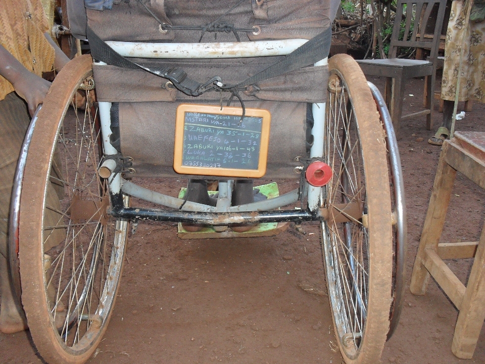 A Kiswahili-version bible verses reminder board attached at the back of the wheelchair. It makes him easy to carry along the uneven terrain to go to the church and avoid him from being forget to bring that stuff.