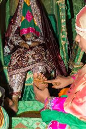 Soon Thuraya's feet will be covered with the strong henna paste, starting with the soles  where already a yellow stain is leaving its marks, and later her hands will also get their share of the paste. In the next two days the bride will have extra sessions of Henna painting, to get the color as dark red as possible and to add the fine pattern and decoration over the edge of the solid areas .: by hawwa, Views[1167]