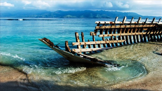 Shipwreck; indonesians pull apart this washed up wreck
