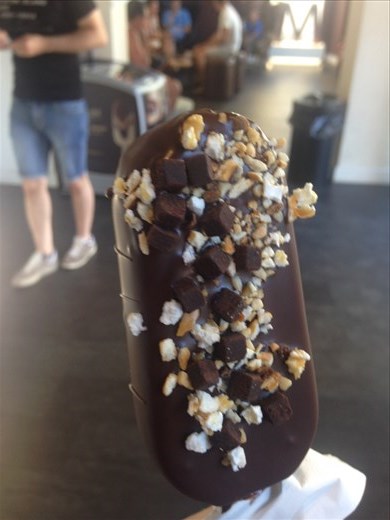 My customized Magnum bar. I chose to have a vanilla ice cream bar dipped in dark chocolate, topped with caramel popcorn pieces, pretzel pieces, and brownie bites, and drizzled in milk chocolate, Florence