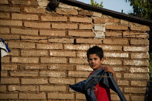 A boy Hangs laundry in a small village near, San Blas Mexico