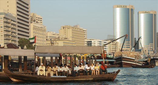Contrast of rich & poor: 30c abra boat ride below ROLEX tower
