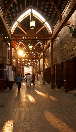 Wooden archways hold the smell of spice & sunlight in Bur Dubai Souq