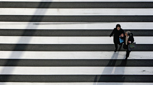 Two elderly mother walking down the street crossing Ginza, Tokyo, Japan.