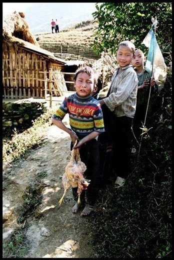 In poor village a boy just caught for stealing a chicken- the owner just behind me