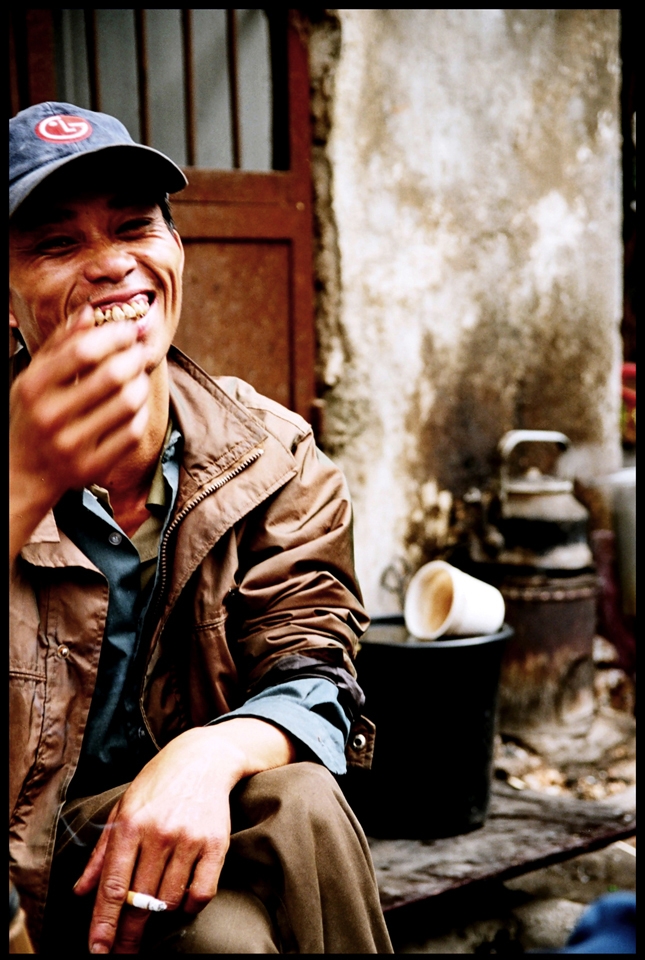 Irrespective of language barriers, a man shares coffee & a laugh on side of road