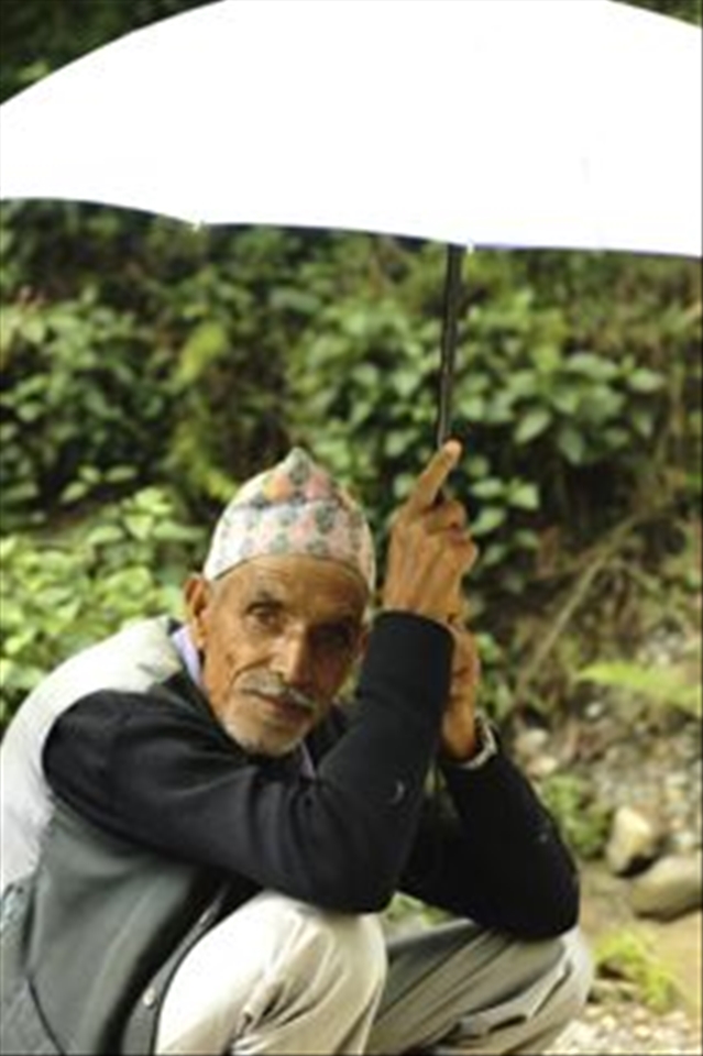 Nepal is hot around the year but that does not keep the people from working. During hot summer days buffalo farmers have to carry large umbrellas to cover themselves from the burning heat whilst their cattle enjoy their daily walk.

