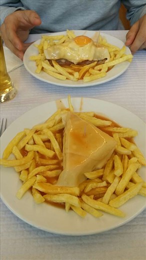 The famous francesinha!! It's bread and sausage meat and sausage and ham and cheese and egg and.. and and... A spicy beer sauce.. and chips! And it is disgustingly good. We went halvies in one. . But the little old Portuguese ladies next to us ate whole ones... each