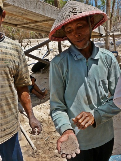 A man clutches the sand containing his living. Gold is extracted from the sand. After many filtration processes, mercury - despite being illegal in Indonesia and damaging to the miners’ health, is used to extract the gold.