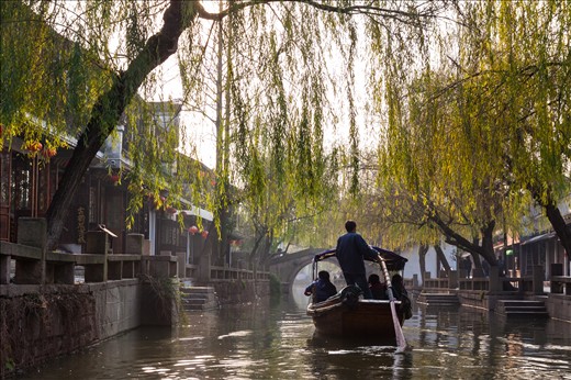 A gondolier paddles through the water village.
