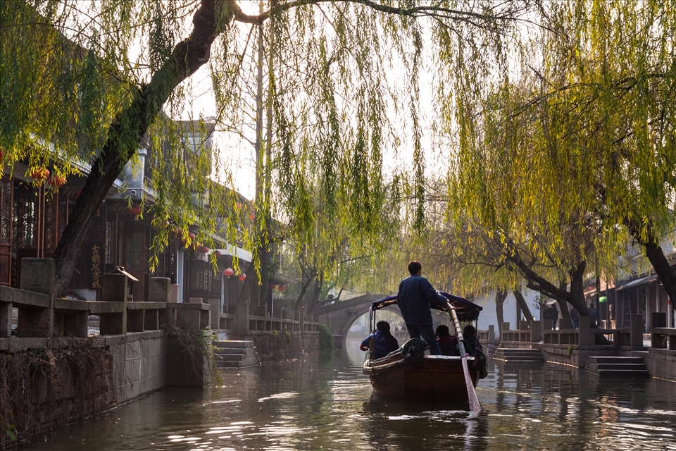 A gondolier paddles through the water village.

