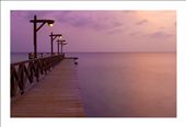 A warm, diffuse sunset casts a pink glow over a wharf in Curacao, the “C” in the ABC islands of the Dutch Antilles off the coast of Venezuela. Serene, and tranquil, this scene is one that is quintessentially Caribbean.: by hoffeman, Views[672]