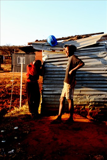 These is a photo of two boys having a chat and sharing jokes