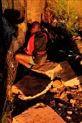 A boy who found a toy in the dump site and is now hiding it away from his friend: by holidayfun, Views[303]