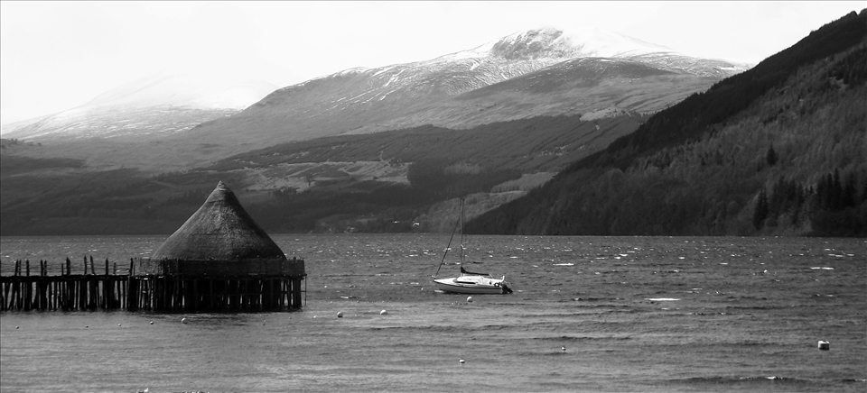 Out in the vast open Loch Tay, a small boat struggles against the tide whilst a wooden crannog sits unchanging. It is the middle of May and the snow atop the looming Beinn Ghlas mountain is beginning to melt. Summer is approaching Scotland.