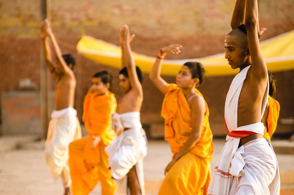 Taken along the Ganges River in Varanasi, India. Walking along the banks of the river in the early hours of the morning, I came across dozens of young Hindu men practicing their Yoga. Their beautiful stances and gentle body language adds a sense of peace and calmness to the frame whilst the sunlight washes them with vivid golden hues.