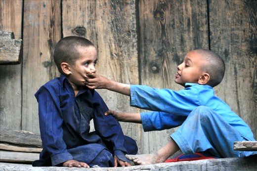 Two brothers fighting over small car-toi in Northern Pakistan, Kalash people val