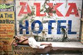 A man lies on a street in Varanasi. Life goes next to him, but he is not interes: by hrvoje, Views[396]
