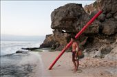 This fisherman was waiting for the right moment to head out to the sea to set up fish traps. The long red pole would be used as a floatation as he swims out.: by hueychiat, Views[361]
