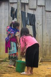 Two young H'mong girls hanging clothes to dry outside their house. : by hungontheworld, Views[448]