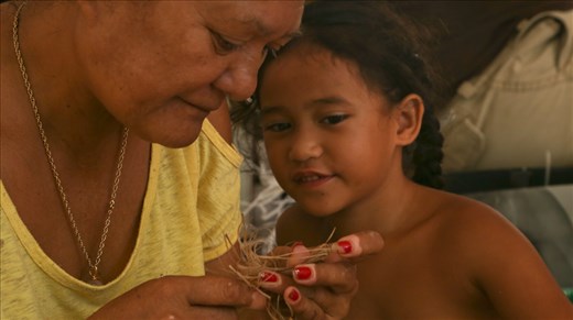 Auntie is patiently showing a little one the art of costume making. According to the Tahitian tradition, you cannot be too young to start learning the ancient dances and costume making. 