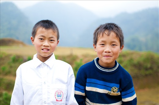 When I travel to Western countries, I have to ask for permission to take pictures of people, especially children. Here in the countryside of Vietnam, especially poor places like mountain villages in Sapa, kids run after you to have their pictures taken. 

In this picture, I love the way these two boys smile. So shy yet so bright.
