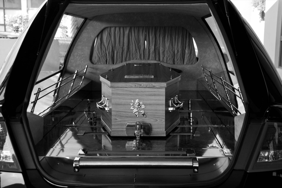 The coffin in the back of the hearse. Ready to be transferred for the funeral.