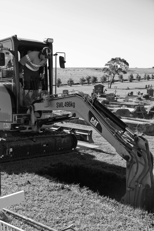 Cemetery gravedigger preparing the grave site.