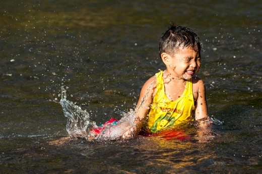 A boy playing a splash of water