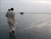 My house-keeper carrying his young son, walks towards the water. His name is Badshah & he requested that his face not be revealed. His father was an Afghan refugee who worked for my extended family. I met Badshah when he was a young boy. After his father's passing, he was raised by my god mother to whom he is ever loyal to this day. Badshah is content with very little. I once asked him if he wished he was richer. He said no. His struggle makes him more grateful for what he has. Not many people are as lucky, he said. It was heartening to see the genuine simplicity in the normal & routine movements of daily living & that people still preferred a simple life. 
When I first arrived in Karachi, Badshah had heard that my wish was to walk on Karachi's sandy beaches. These places hold fond memories as my family use to frequent them often when I was a child. To my pleasant surprise, with only a few days left to my departure, my wish came true when Badshah & his family took me to Seaview & Clifton beaches. I am forever indebted to his generosity & service. : by iamrahma, Views[1573]