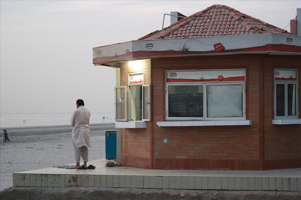 Upon leaving the beach, I saw a man praying facing west towards the Kabaa in Mecca. 
For me, this was a sight to behold. He appeared transfixed in worship, undisturbed by the presence of the gathering crowds. 
Wherever I went in Karachi my camera came with me. I was captivated by the sights, sounds & multitude of textures. What I saw as strange & even simply beautiful to the locals it was part of the mundane, daily routine. This imperfect yet authentic & real Karachi was starring right at me. You used to be a part of this nation but it’s no longer yours. Yet still somehow our lives intertwined. 