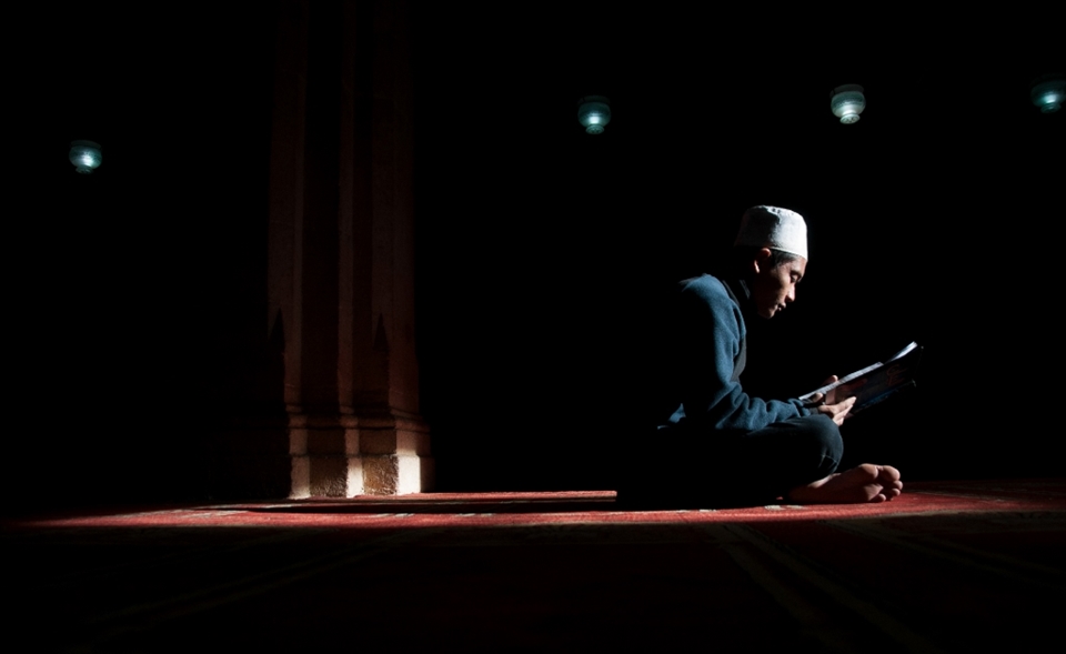 An indonesian international student is studying inside the Azhar-mosque under the sun's golden rays which coming through a small opened window up in the ceiling.this mosque used to be an important distenation for eny student who is interested in Islamic studies.