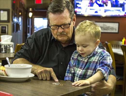 The mayor of London teaches his grandson, Easton, how to count change.