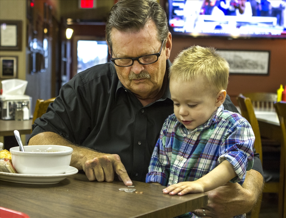 The mayor of London teaches his grandson, Easton, how to count change.