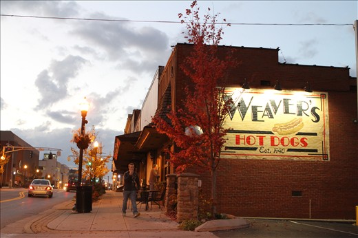 A patron enters Weaver's Hotdogs just after opening in the morning. 