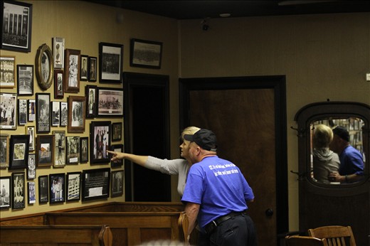 A couple takes a minute to reminisce (with their arms around eachother). 