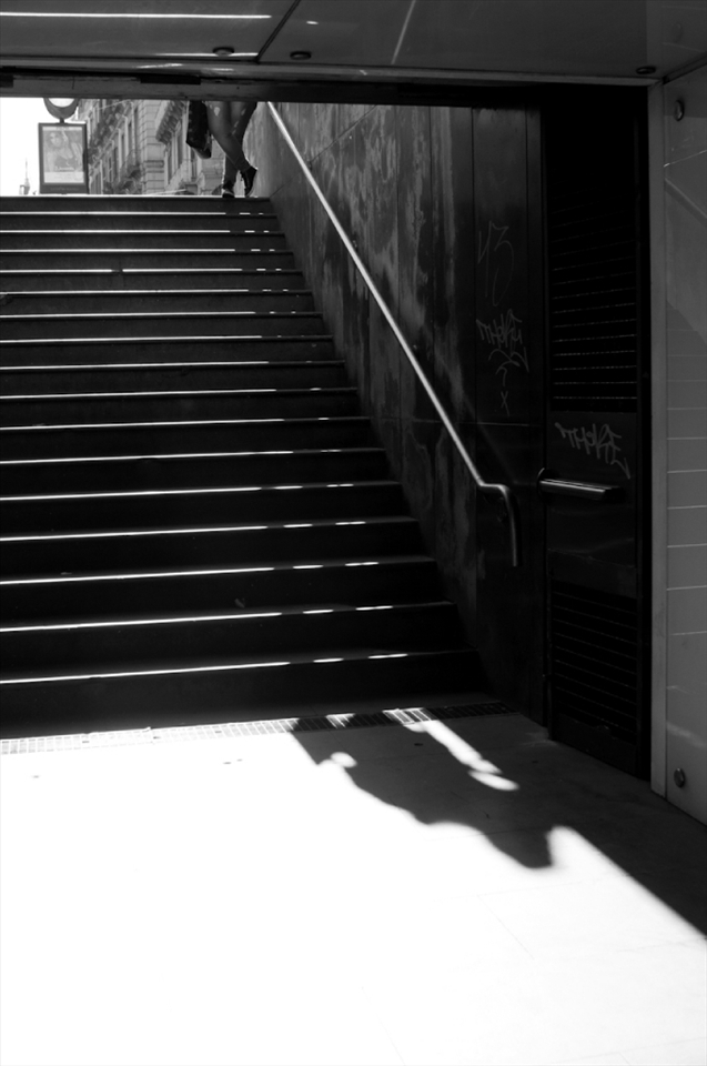 Naples City Metro entrance. Some girl waiting probably for her boyfriend or friends at the street level. It's popular place of meeting in city centre.