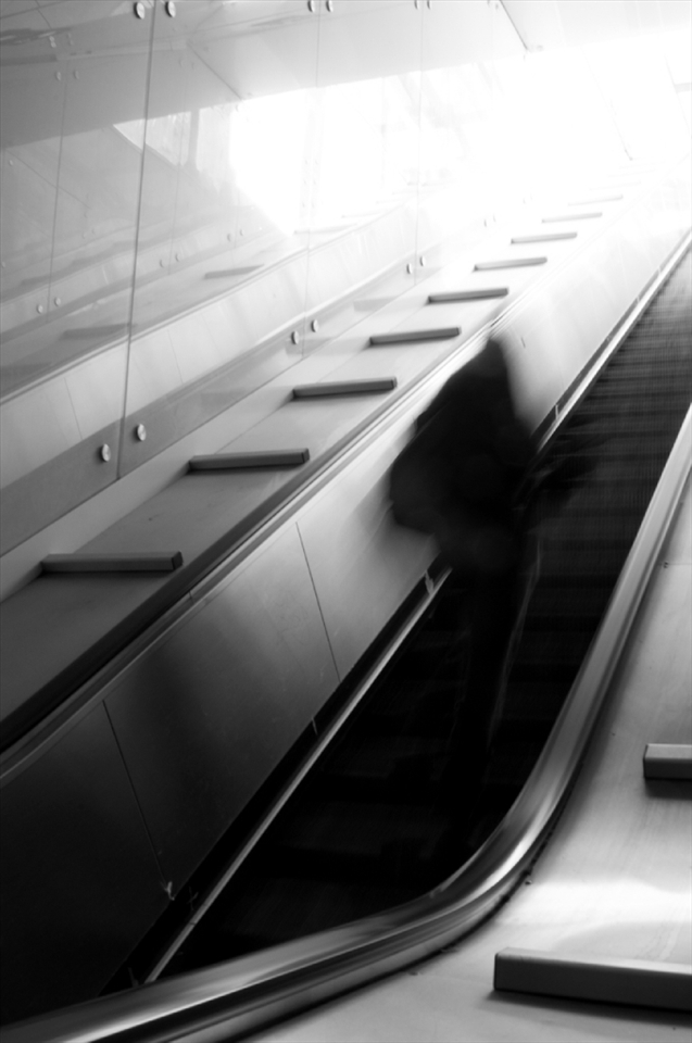 Naples City Metro escalator. Some woman hurring to exit. Despite being in general relaxed and leisurely, Neapolitans have some strange habit of being in hurry.
