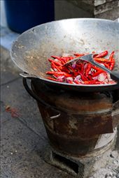 Essential Thai cuisine ingredients (chilli pepper, garlic and shallots) are ready to be cooked in a wok on an open fire stove under the Memorial Bridge in Bangkok, Thailand. : by igory, Views[1105]