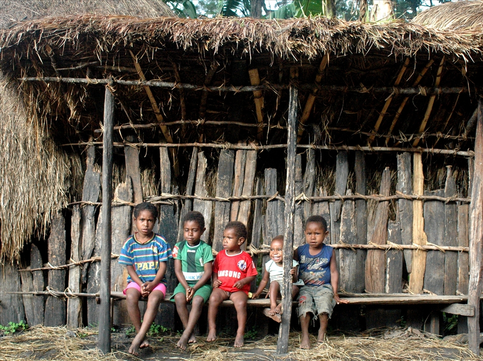 Children in Obia Village, Papua. They're vulnerable to malaria but still smiling