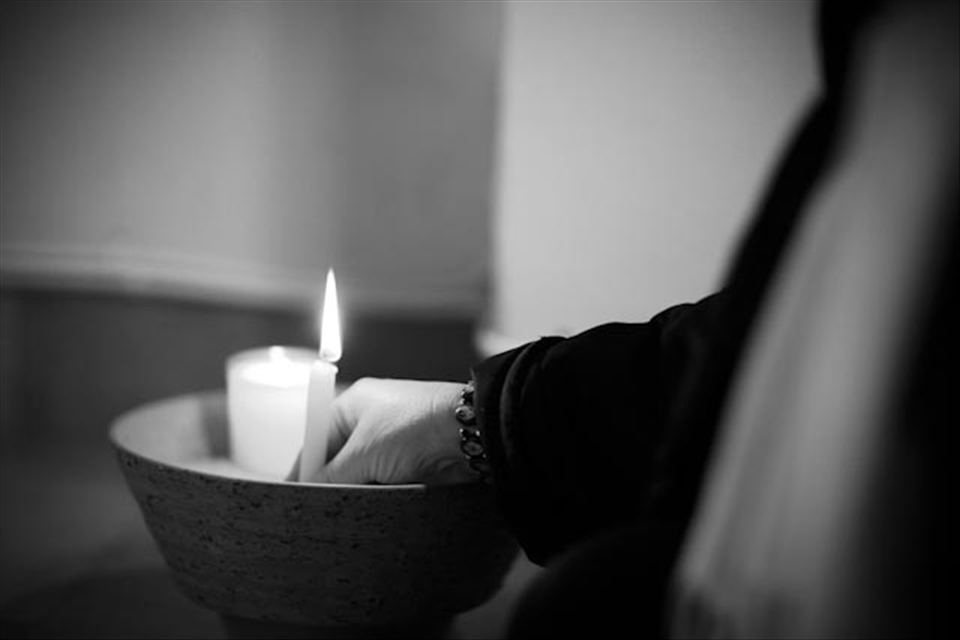 The lighting of a candle at St Saviour's Priory, representing a spiritual moment