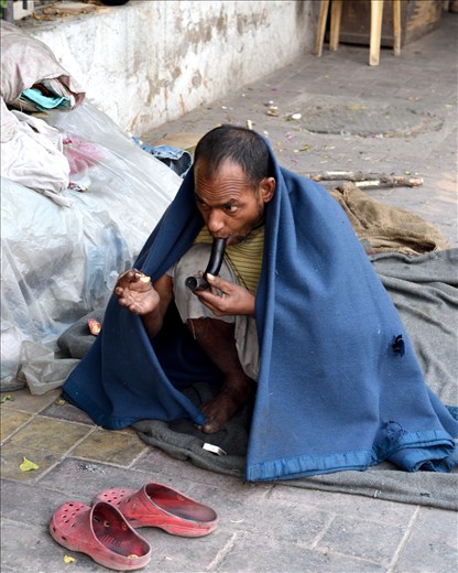Man smoking a shoe-polish to get his pleasure.