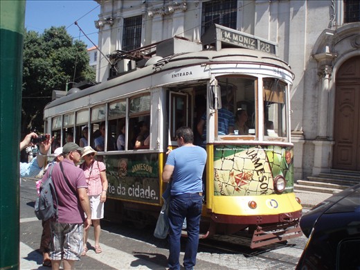 Tourists lining up and entering on tram 28