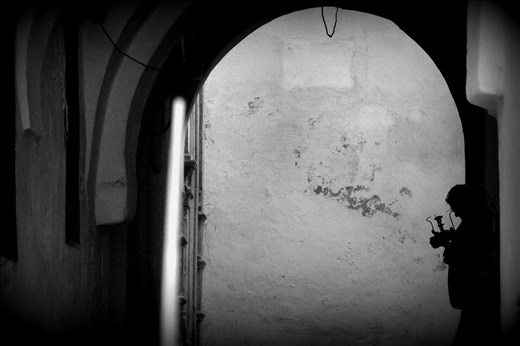 A shadow, a man cleaning his teapot