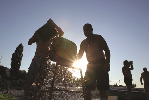 It's late in the afternoon.  Two fishermen after catch. They clean mussels.