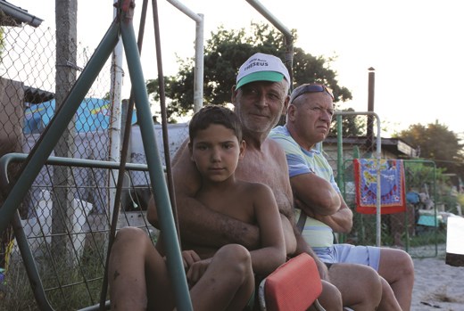 Child and his grandfather in front of their fishing house.
