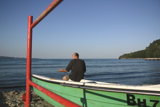 Awaiting  fisherman looking the sea.