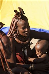 Women gather by the sacred fire to care for the kids. The Himbas use a mix of ochre and fat to avoid sunburn and skin infections. : by intotheworld, Views[557]